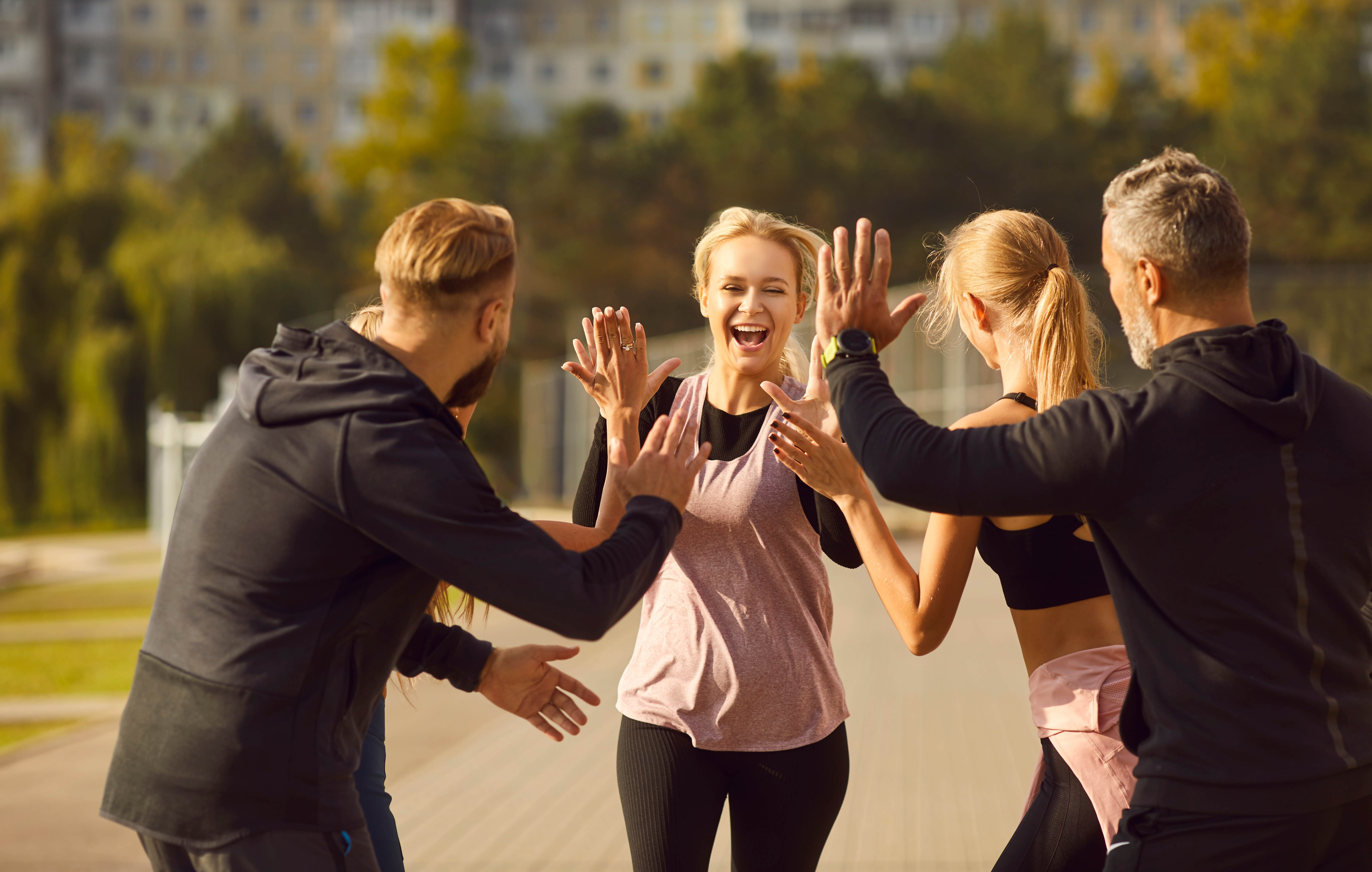 Group of people celebrating each other's fitness and workout successes